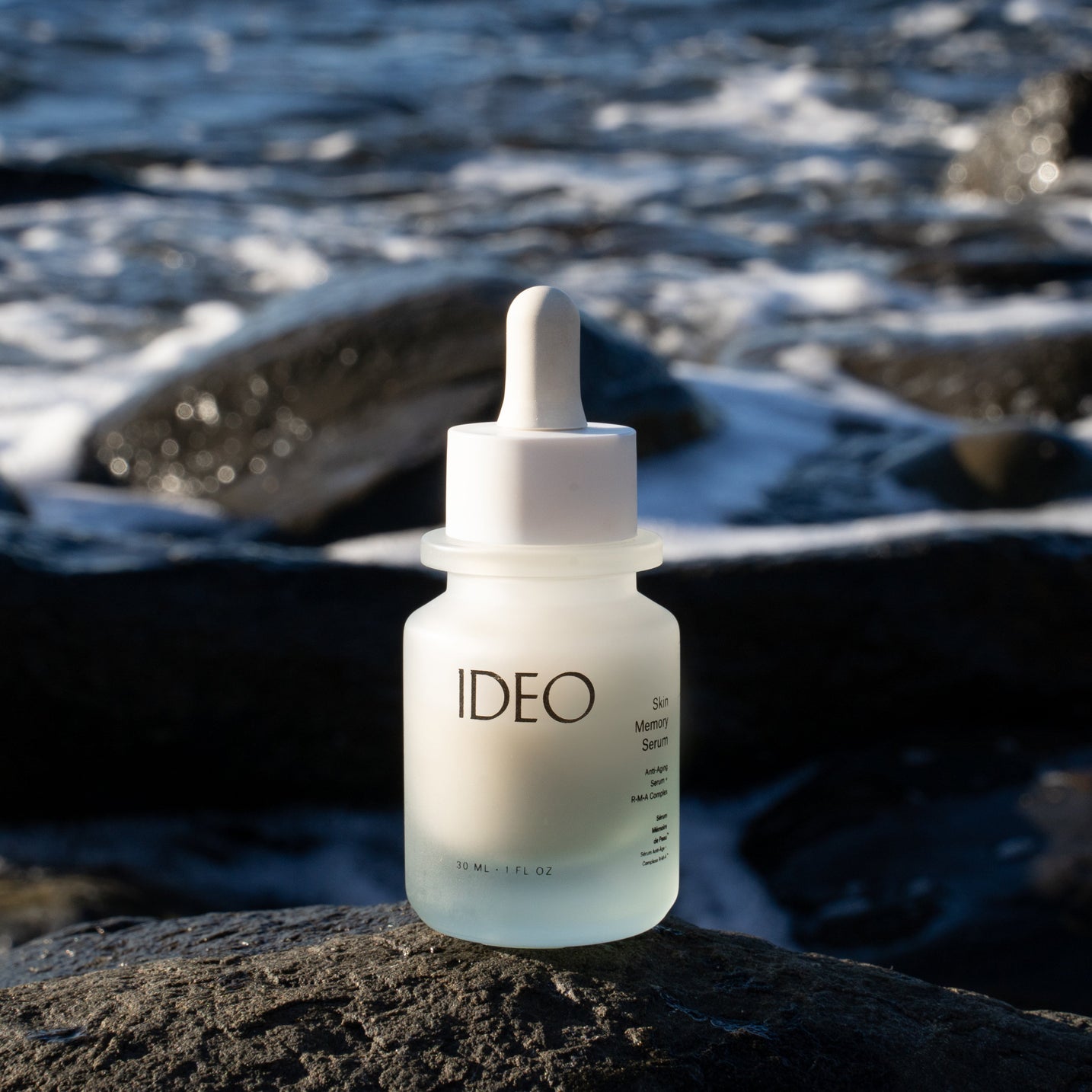 IDEO Skin Memory Serum bottle at beach for Memorial Day