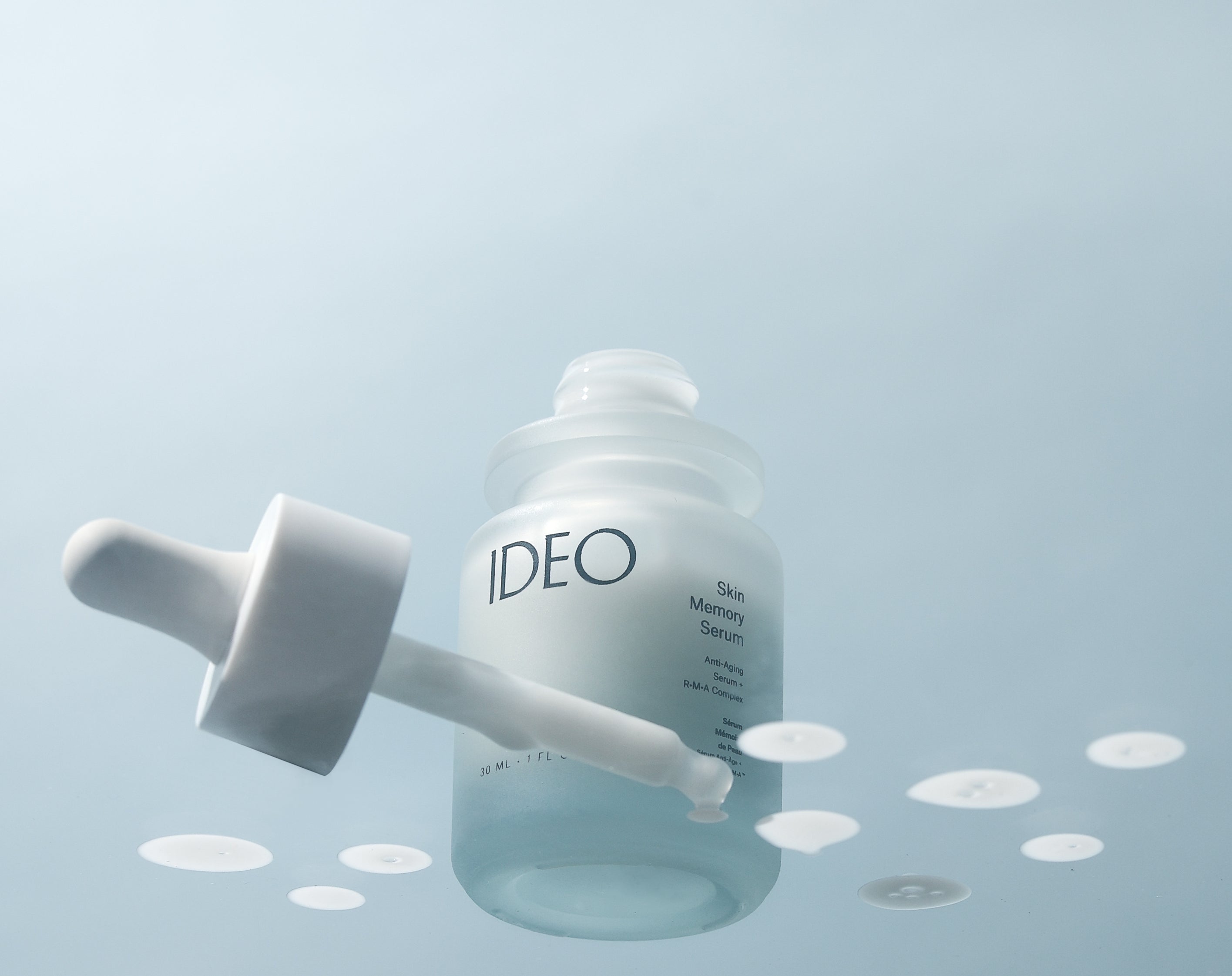 IDEO Skin Memory Serum IDEO skincare bottle with dropper and drops of serum in hero shot