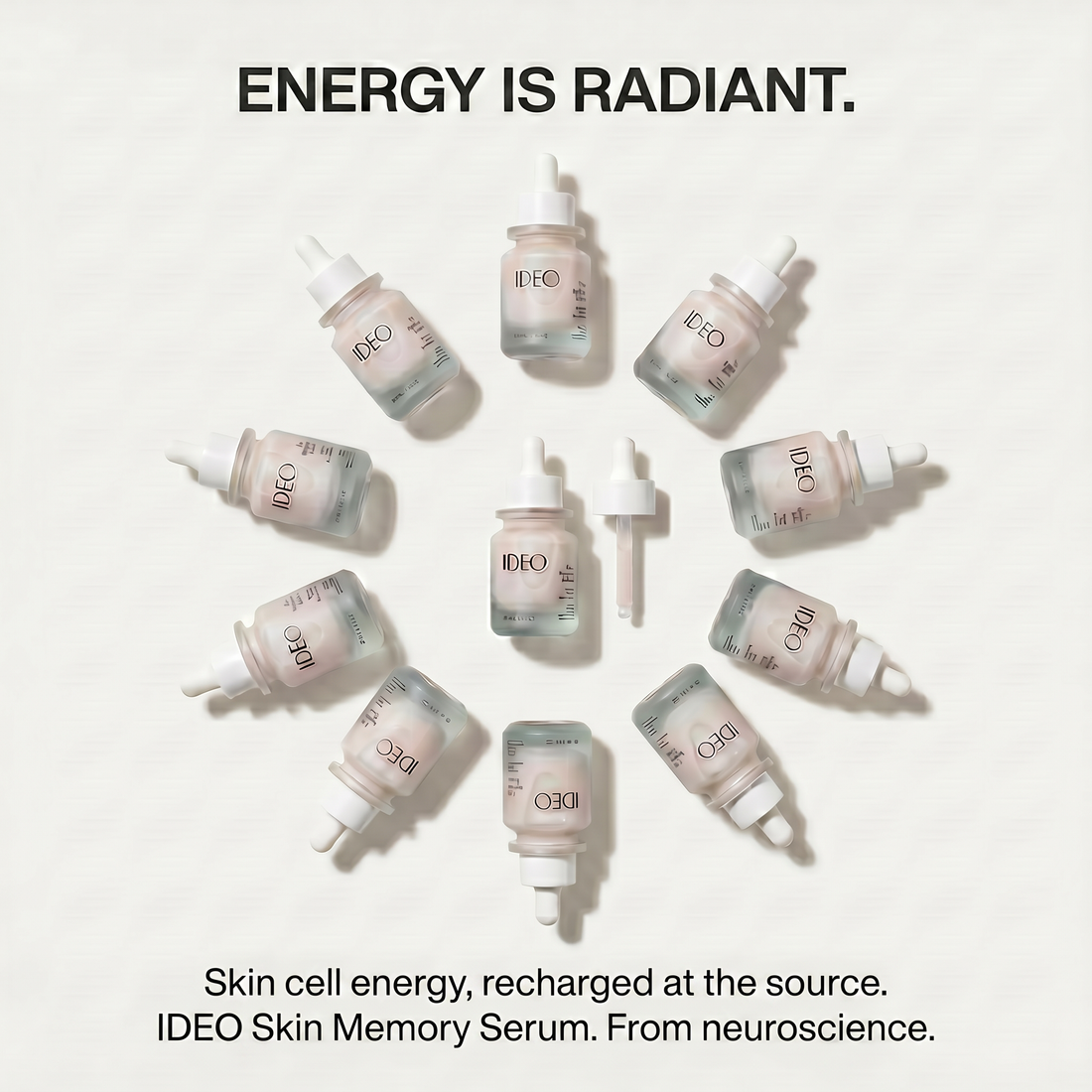 IDEO Skin Memory Serum and dropper surrounded by bottles of the serum in radiant formation