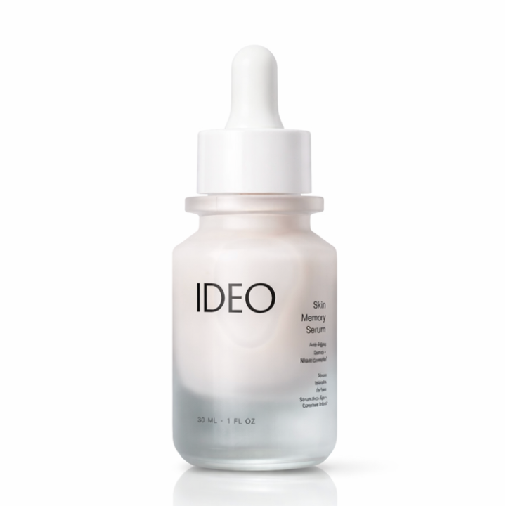 A frosted glass dropper bottle of IDEO Skin Memory Serum with a white dropper cap, shown on a clean white background with a soft reflection.